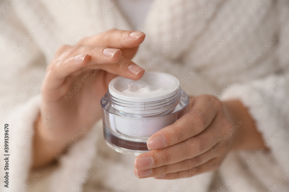 Woman with jar of moisturizing cream, closeup Woman with jar of moisturizing cream, closeup