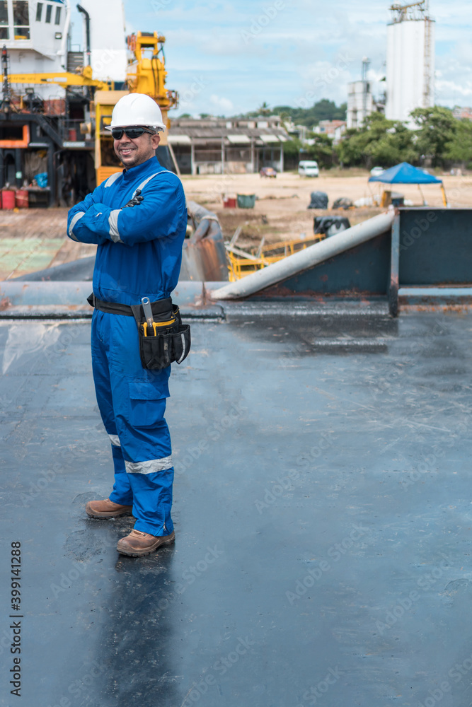 Hispanic deck officer on ship deck, with PPE personal protective equipment. Dream job at sea Hispanic deck officer on ship deck, with PPE personal protective equipment. Dream job at sea