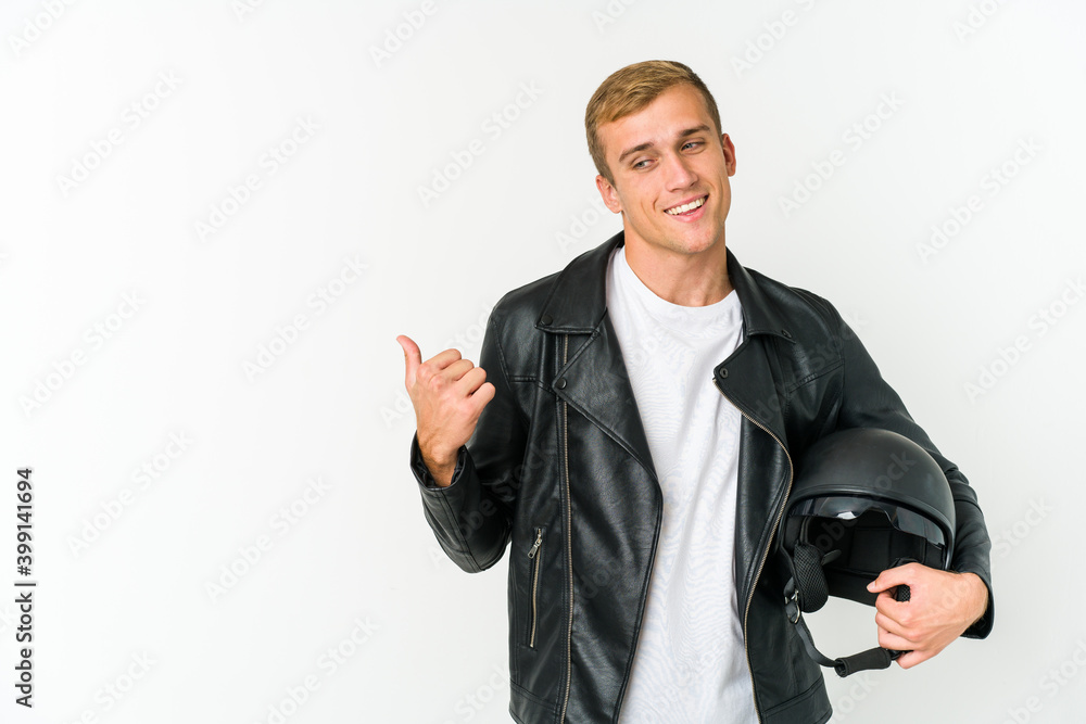 Young caucasian man holding a motorbike helmet isolated on white background Young caucasian man holding a motorbike helmet isolated on white background