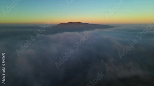 Sunrise over the Beshtau mountains and low clouds. Location Russia, Pyatigorsk. Copter photo