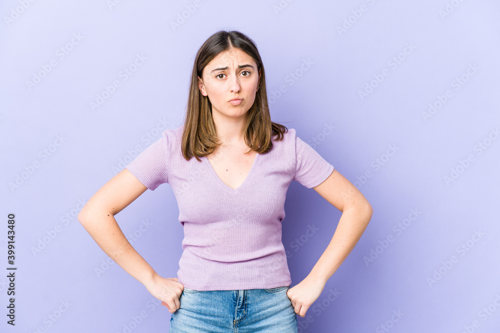 Young caucasian woman blows cheeks, has tired expression. Facial expression concept. Young caucasian woman blows cheeks, has tired expression. Facial expression concept.