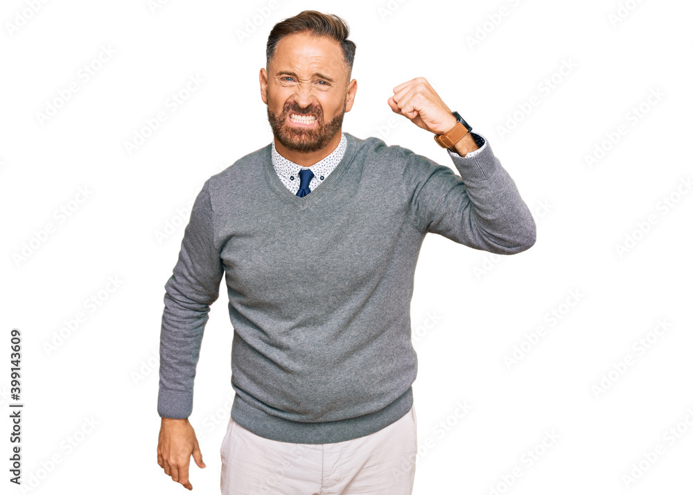 Handsome middle age man wearing business clothes angry and mad raising fist frustrated and furious while shouting with anger. rage and aggressive concept. Handsome middle age man wearing business clothes angry and mad raising fist frustrated and furious while shouting with anger. rage and aggressive concept.