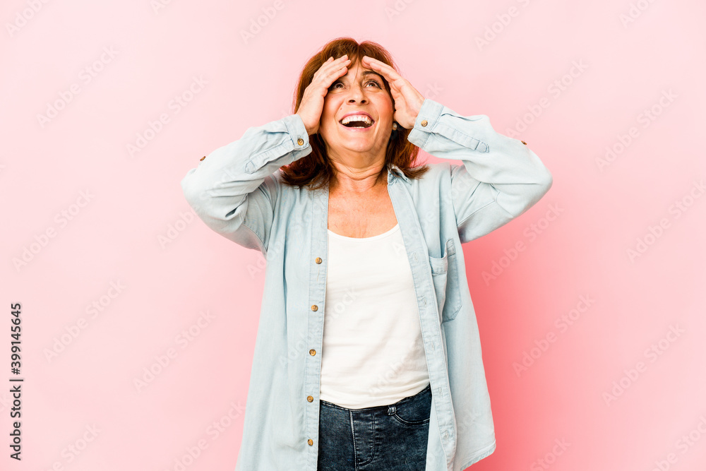 Senior caucasian woman isolated laughs joyfully keeping hands on head. Happiness concept. Senior caucasian woman isolated laughs joyfully keeping hands on head. Happiness concept.