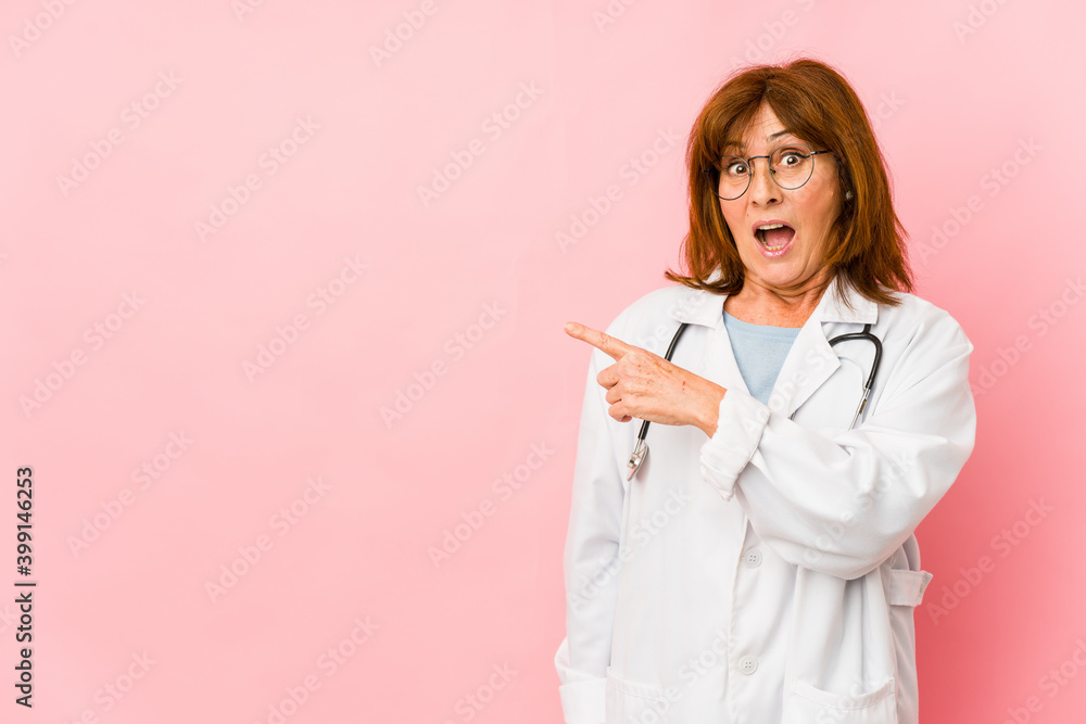 Middle age caucasian doctor woman isolated pointing to the side