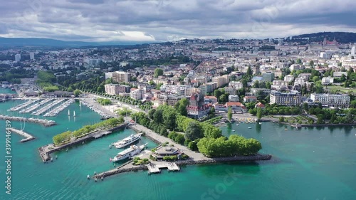 View from Lake Leman of residential areas of Swiss city of Lausanne in cloudy summer day, canton of Vaud in Romandy
