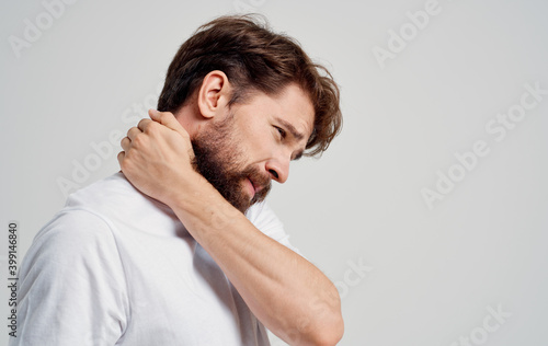 young man touching neck with hands spine pain side view model portrait