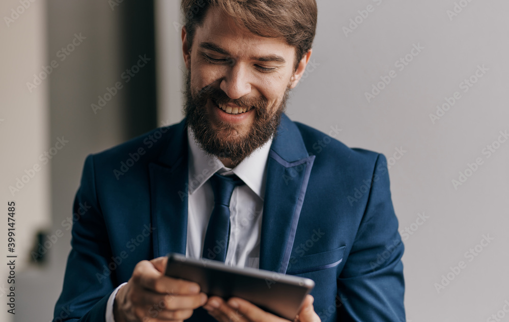 Cheerful business man with a tablet in the hands of technology Professional Cheerful business man with a tablet in the hands of technology Professional