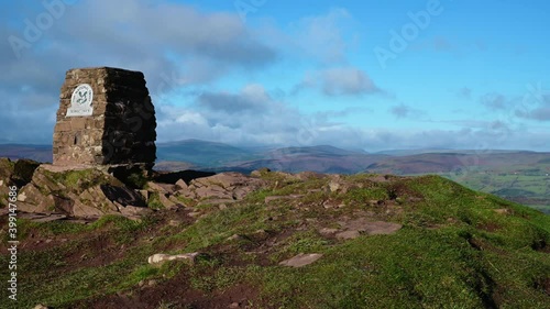 View of Skirrid fawr peak with clouds passing over on a windy day south wales uk. photo