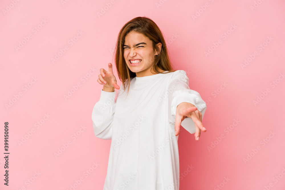 Young skinny caucasian teenager girl showing claws imitating a cat, aggressive gesture. Young skinny caucasian teenager girl showing claws imitating a cat, aggressive gesture.