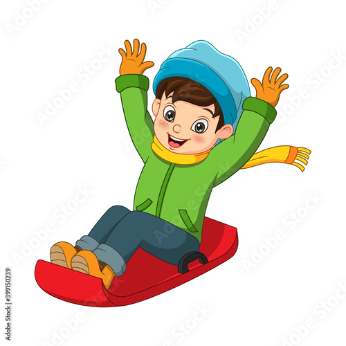 Cute little boy sliding down the hill