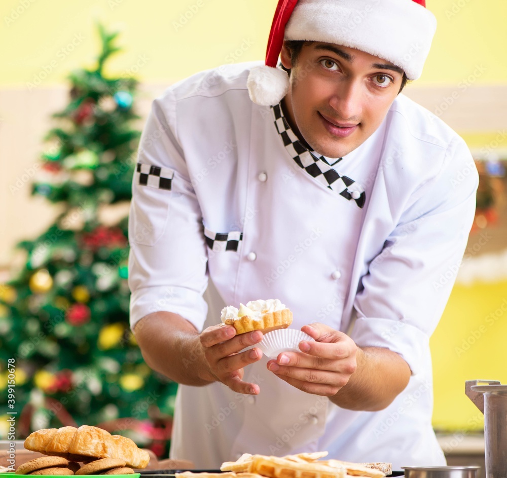 Young chef husband working in kitchen at Christmas eve Young chef husband working in kitchen at Christmas eve