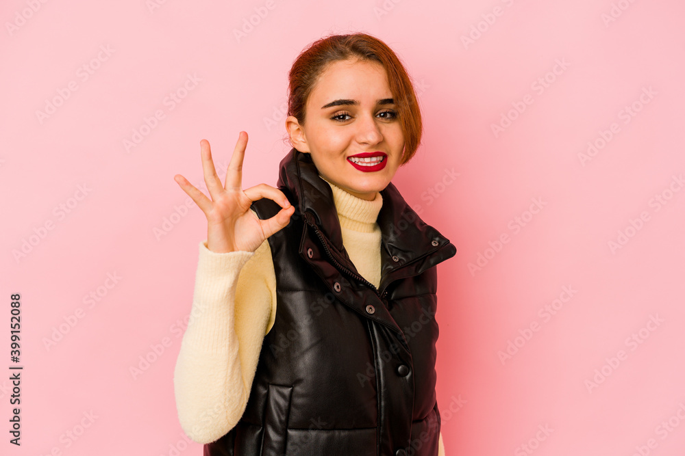 Young arab mixed race woman cheerful and confident showing ok gesture. Young arab mixed race woman cheerful and confident showing ok gesture.