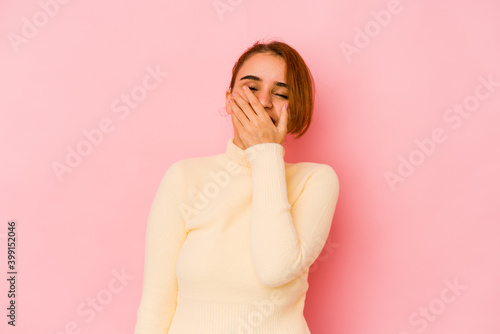 Young arab mixed race woman laughing happy, carefree, natural emotion.