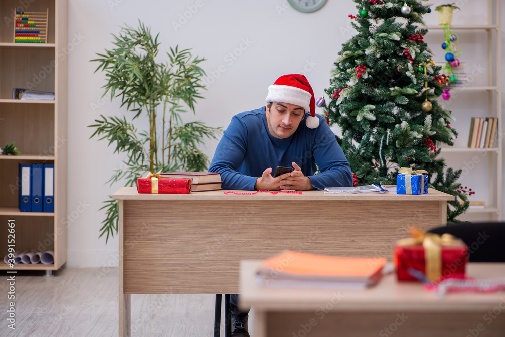 Young male student preparing for exams during new year celebrati Young male student preparing for exams during new year celebrati