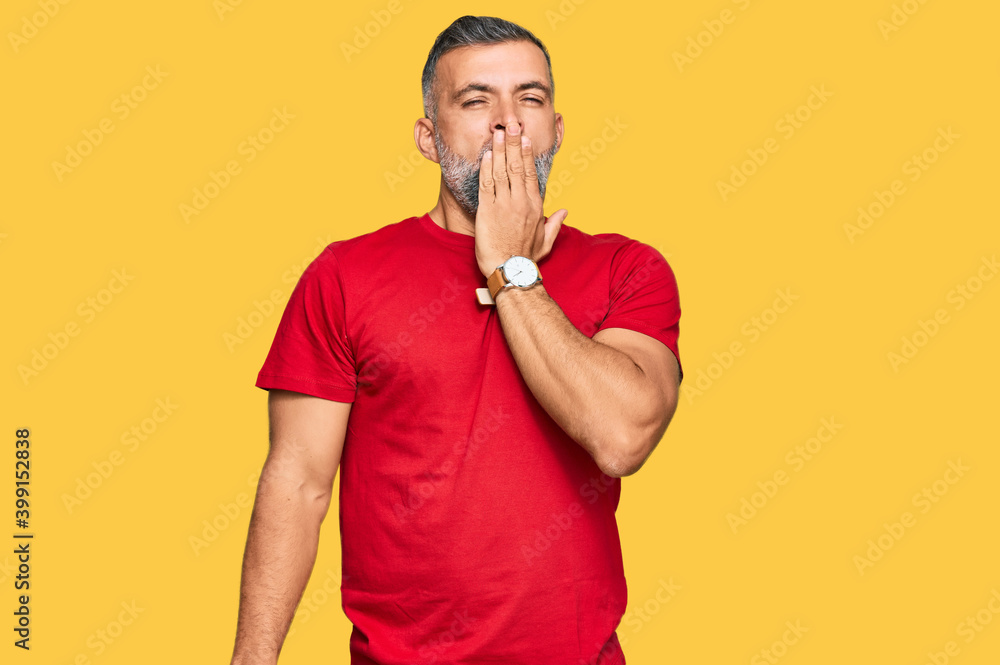 Middle age handsome man wearing casual clothes bored yawning tired covering mouth with hand. restless and sleepiness. Middle age handsome man wearing casual clothes bored yawning tired covering mouth with hand. restless and sleepiness.