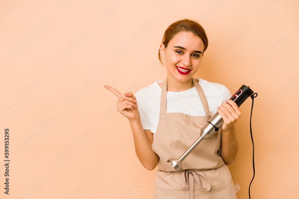 Young skinny arab cook woman smiling and pointing aside, showing something at blank space. Young skinny arab cook woman smiling and pointing aside, showing something at blank space.