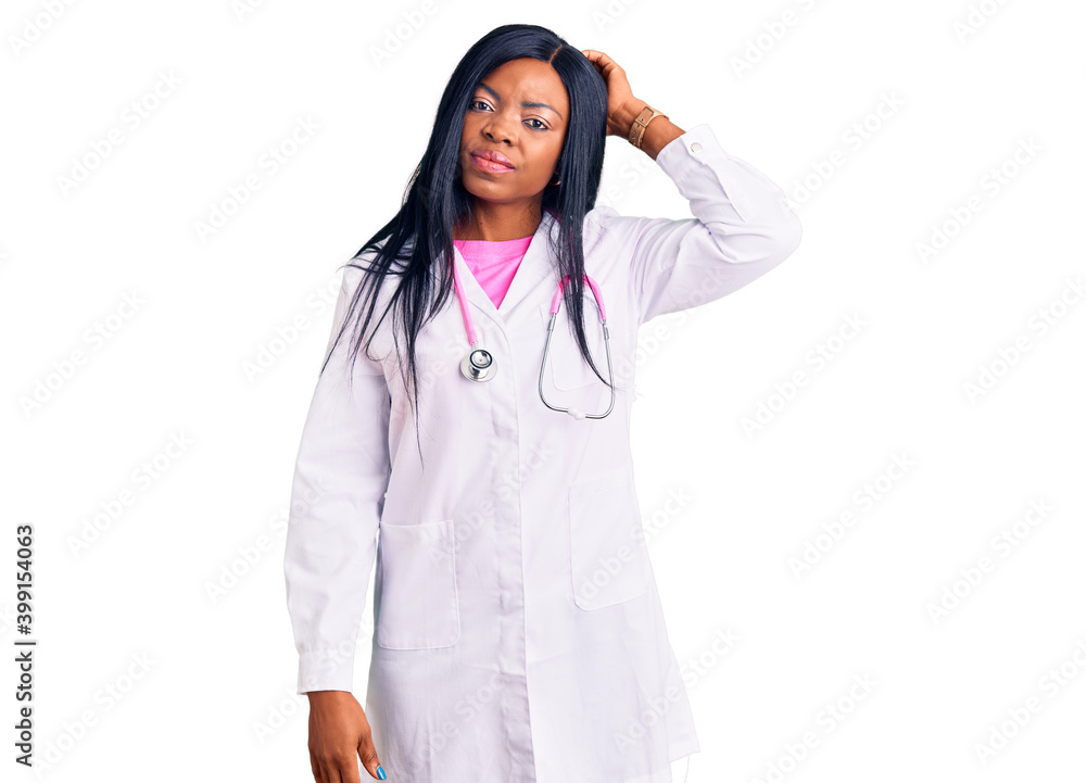 Young african american woman wearing doctor stethoscope confuse and wondering about question. uncertain with doubt, thinking with hand on head. pensive concept. Young african american woman wearing doctor stethoscope confuse and wondering about question. uncertain with doubt, thinking with hand on head. pensive concept.