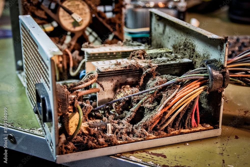 Foto de Extremely dirty broken computer power supply with a lot of dirt and dust. Close up
