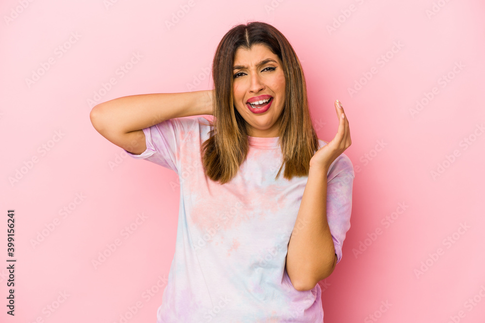Young indian woman isolated on pink background screaming with rage. Young indian woman isolated on pink background screaming with rage.