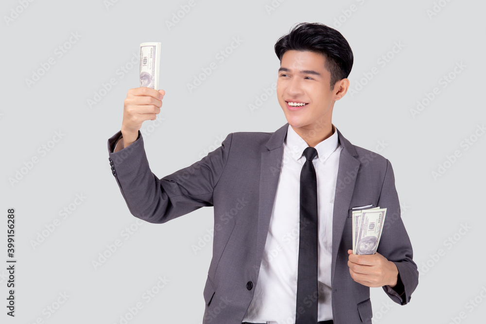 Young asian business man holding money dollar isolated on white background, businessman in suit holding banknote and success and excited with finance, savings and investment, income and spending. Young asian business man holding money dollar isolated on white background, businessman in suit holding banknote and success and excited with finance, savings and investment, income and spending.