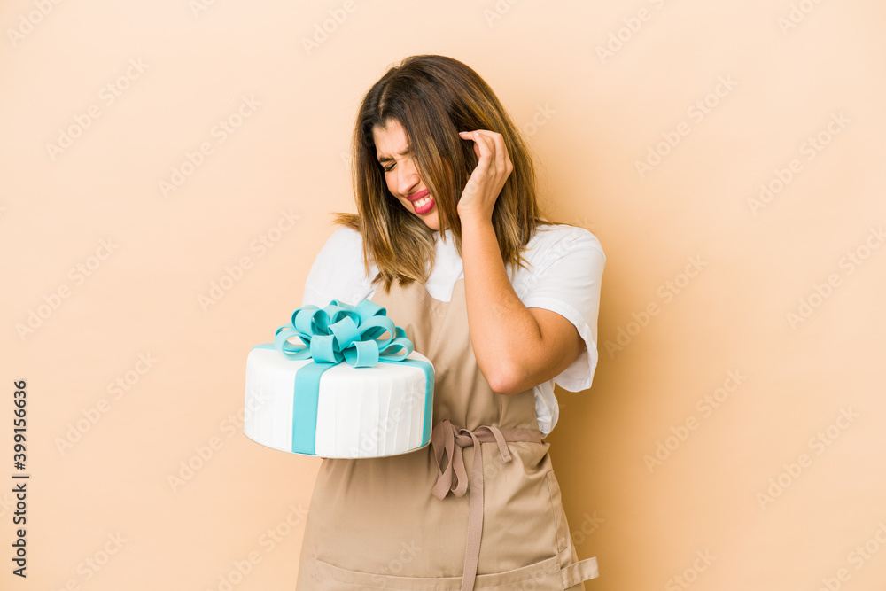 Young indian pastry chef woman isolated covering ears with hands. Young indian pastry chef woman isolated covering ears with hands.