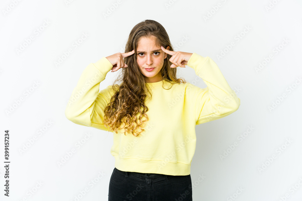 Young caucasian woman focused on a task, keeping forefingers pointing head. Young caucasian woman focused on a task, keeping forefingers pointing head.