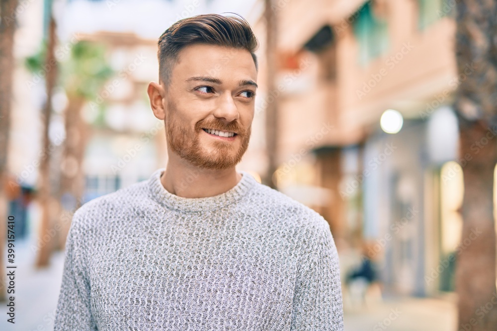 Young caucasian man smiling happy standing at the city. Young caucasian man smiling happy standing at the city.
