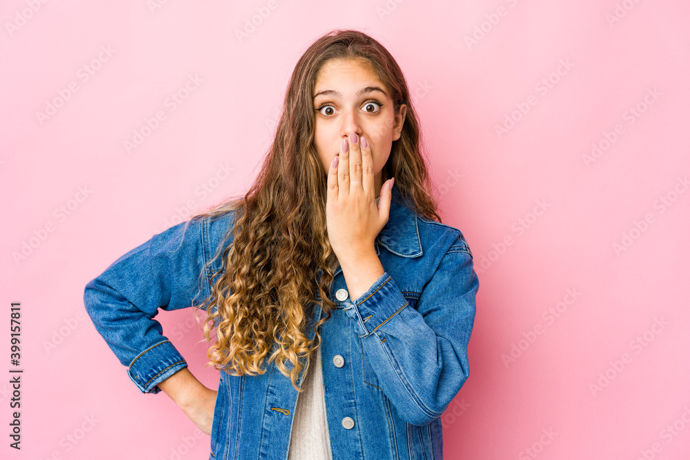 Young caucasian woman shocked, covering mouth with hands, anxious to discover something new. Young caucasian woman shocked, covering mouth with hands, anxious to discover something new.