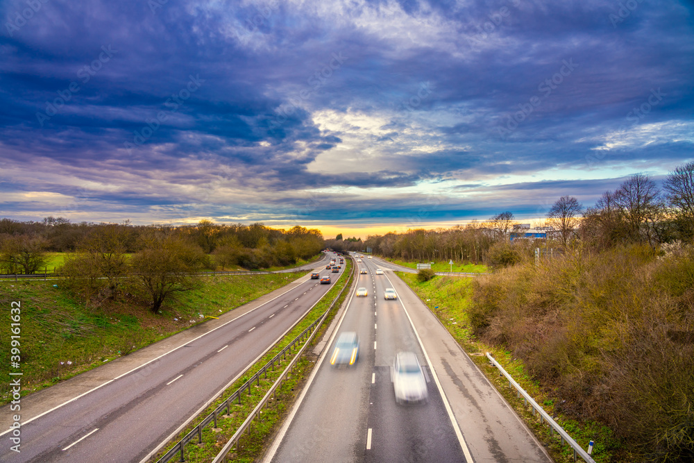 Blurry cars on A1M motorwayy in England at sunset