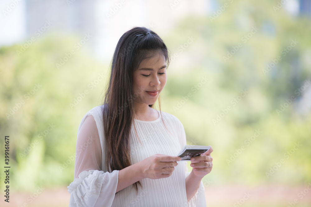 Pregnant Asian women are exercising for prenatal health care in the park. Pregnant Asian women are exercising for prenatal health care in the park.