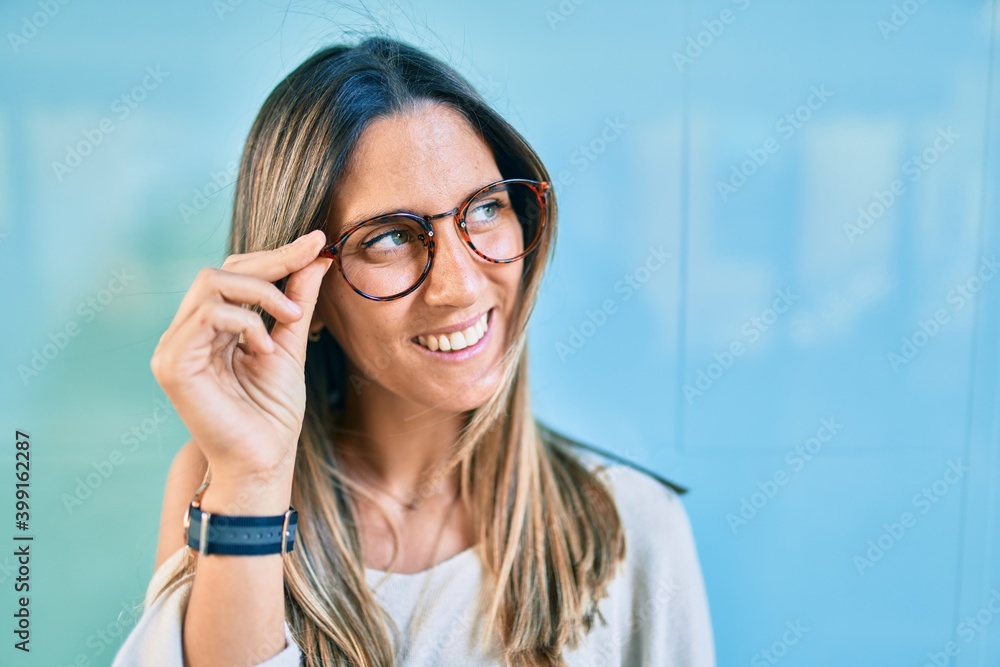 Young caucasian woman smiling happy walking at the city. Young caucasian woman smiling happy walking at the city.
