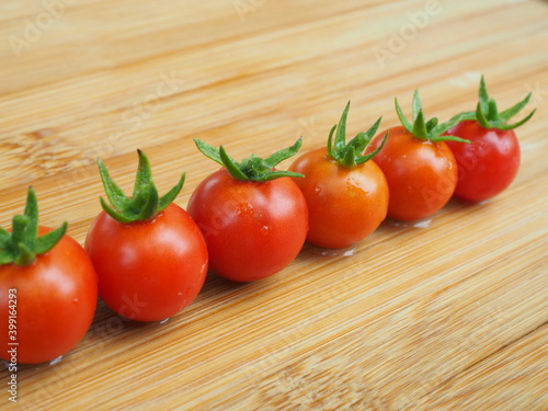 Ripe tomatoes on wooden board background, Fresh cherry tomatoes on wooden background, tomatoes on wooden background, Selective focus.