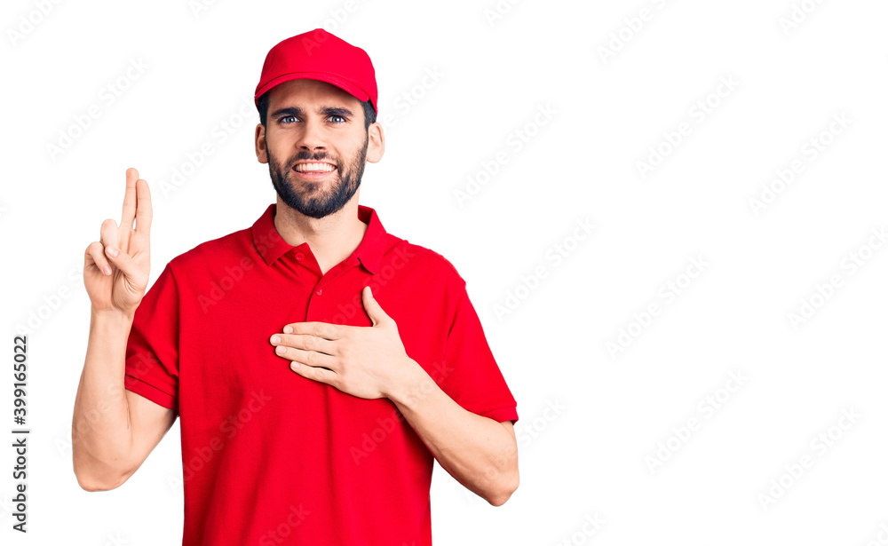 Young handsome man with beard wearing delivery uniform smiling swearing with hand on chest and fingers up, making a loyalty promise oath Young handsome man with beard wearing delivery uniform smiling swearing with hand on chest and fingers up, making a loyalty promise oath