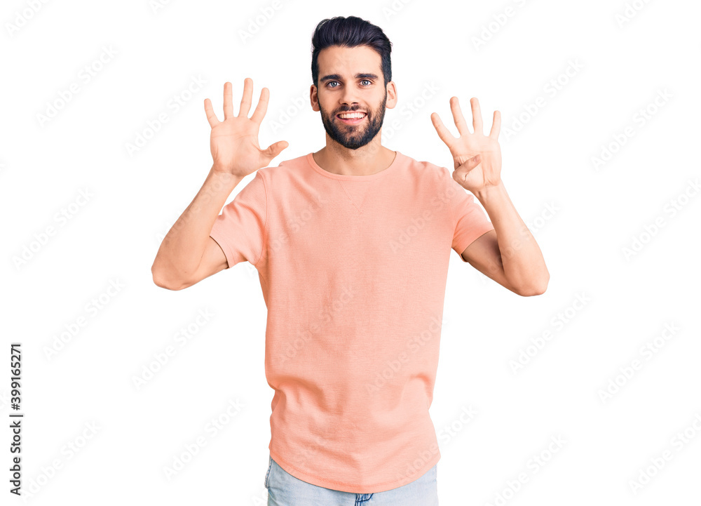 Young handsome man with beard wearing casual t-shirt showing and pointing up with fingers number nine while smiling confident and happy. Young handsome man with beard wearing casual t-shirt showing and pointing up with fingers number nine while smiling confident and happy.