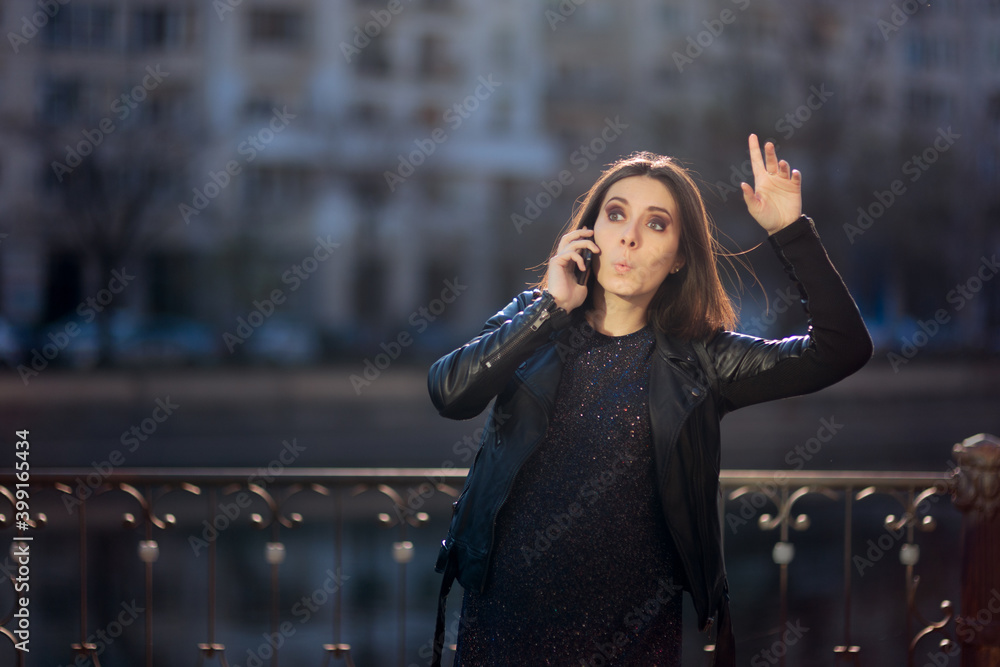 Fototapeta premium Pregnant Woman Hailing a Taxi Talking on the Phone