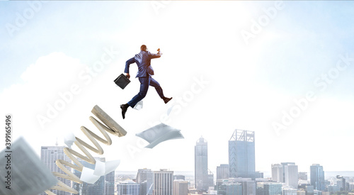 Businessman jumping on springboard . Mixed media © Sergey Nivens