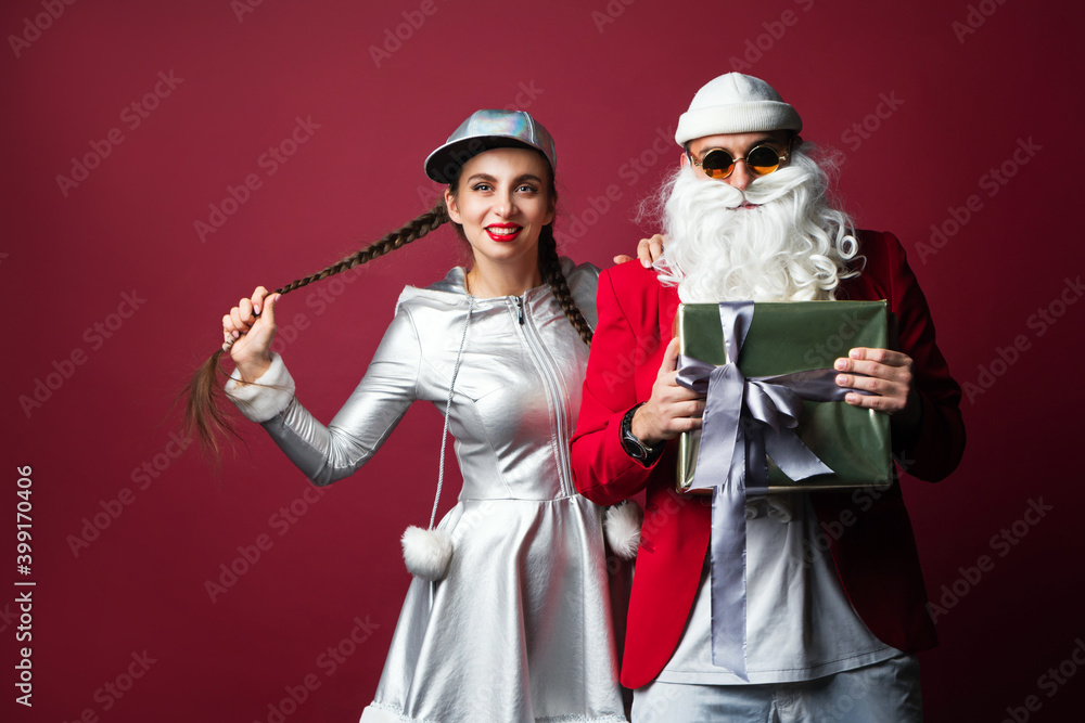 Dj Santa Claus with Sunglasses and Headphones Listening to Christmas Music and Snow Maiden Having Fun. Hip Hop Xmas Party Time.