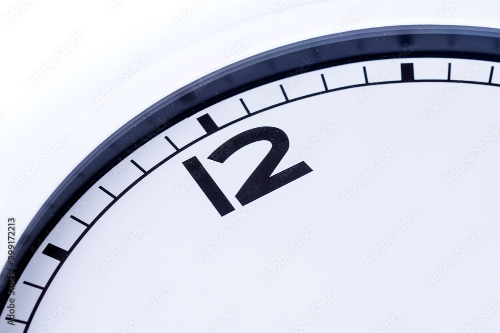 Close up quarter of an analog clock showing the hour of twelve Close up quarter of an analog clock showing the hour of twelve