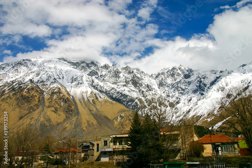 Stepantsminda (Kazbegi) town surrounded by the Greater Caucasus Mountains
