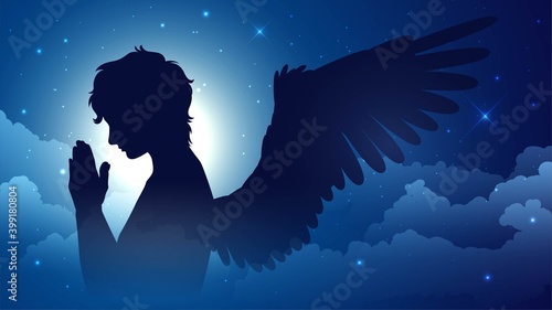 Praying silhouette of an angel on a background of the starry sky