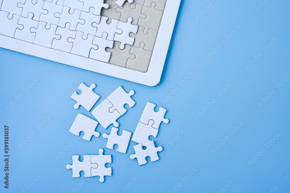White jigsaw puzzle on blue background. White jigsaw puzzle on blue background.