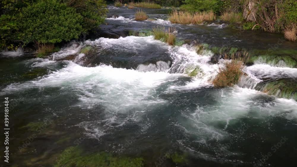 Water flowing from one tier to another with green and light brown plants interspersed at Krka National Park in Croatia Water flowing from one tier to another with green and light brown plants interspersed at Krka National Park in Croatia