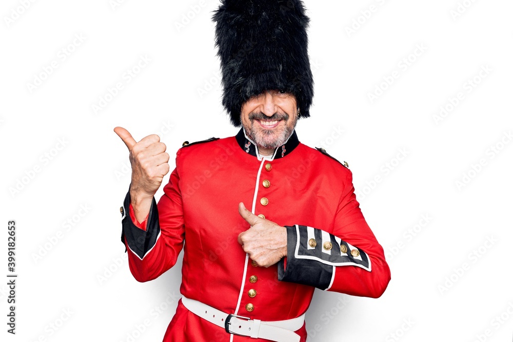 Middle age handsome wales guard man wearing traditional uniform over ...