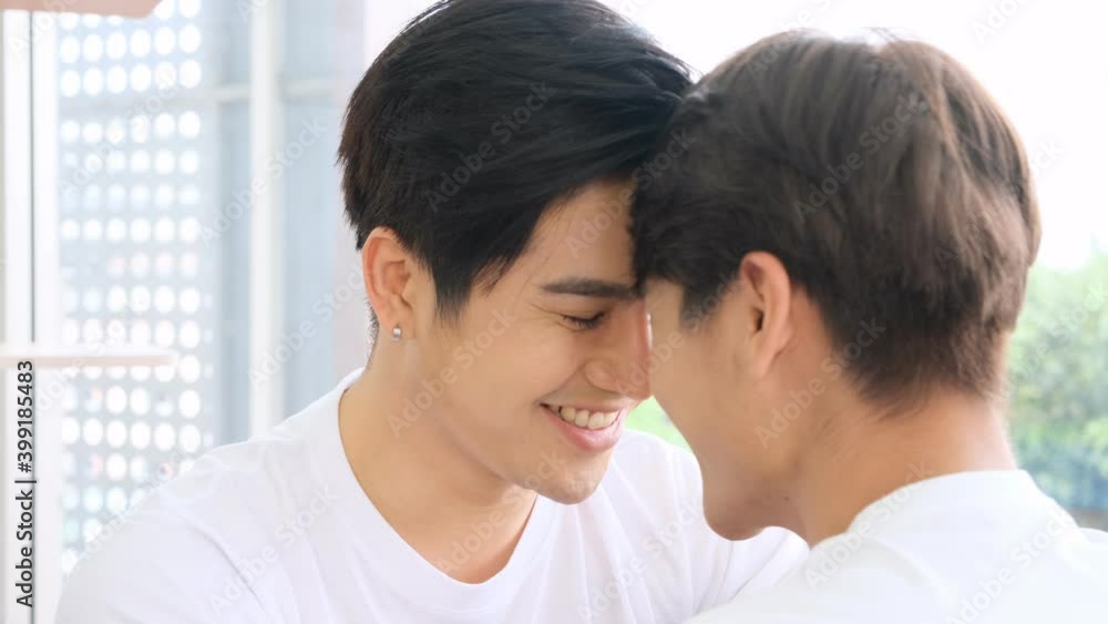 Asian gay lgbt couple looking into each other's eyes and kiss happily together,homosexual and lgbt concept. Asian gay lgbt couple looking into each other's eyes and kiss happily together,homosexual and lgbt concept.