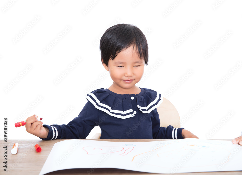Little Chinese girl practicing painting at the table Little Chinese girl practicing painting at the table