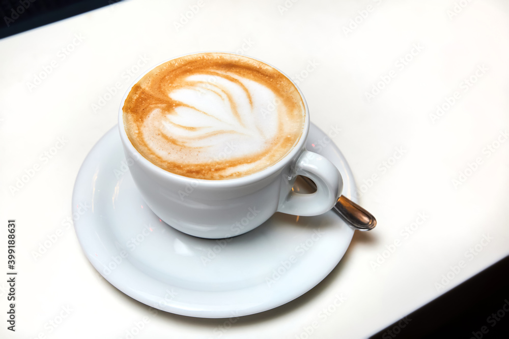 A cup of coffee. Latte with heart pattern in a white cup. A cup of coffee. Latte with heart pattern in a white cup.