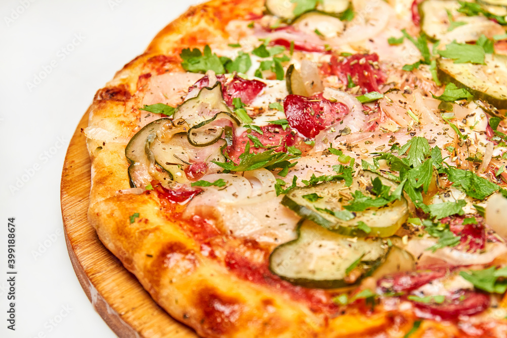 Fresh pizza pickles, bacon, sausages and cheese on a wooden board. Close-up, selective focus