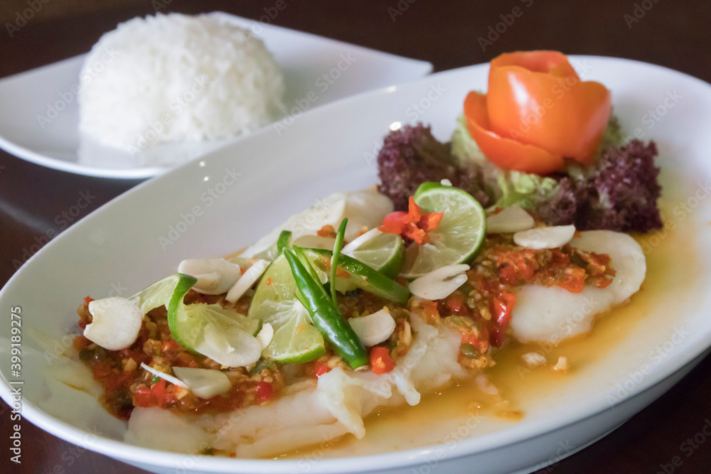 Steamed Thai dory fish with lime, chili and garlic served with steamed rice Steamed Thai dory fish with lime, chili and garlic served with steamed rice