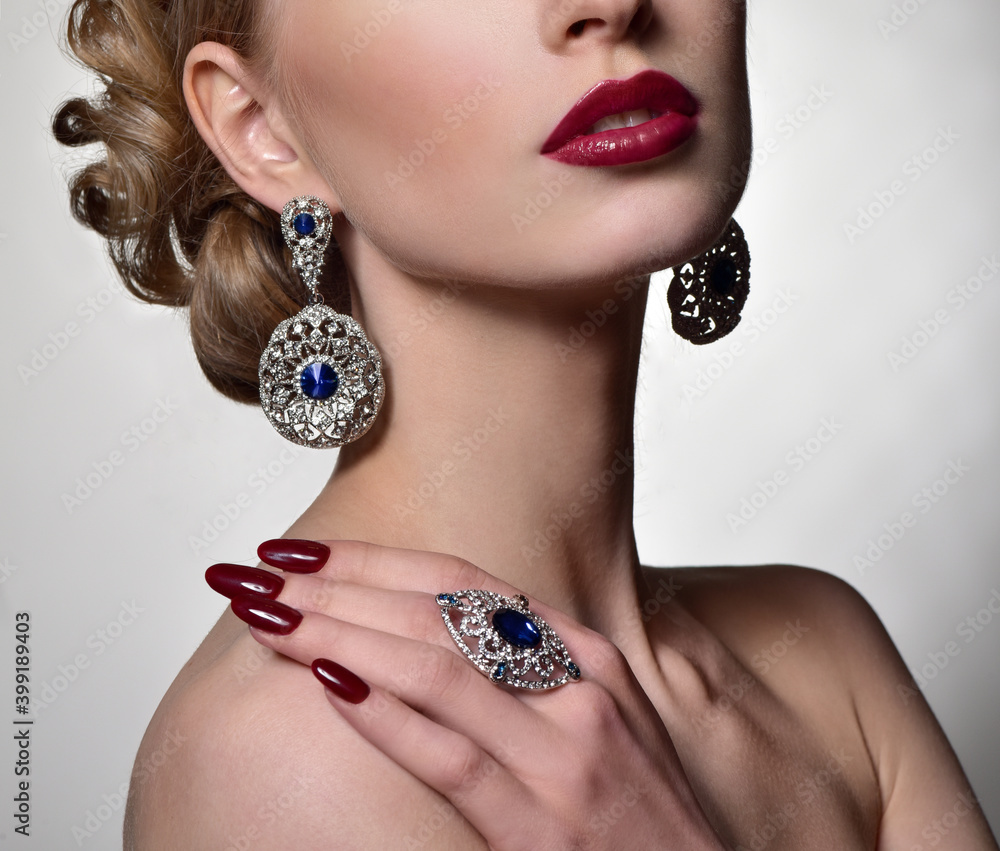 Beauty Woman in jewelry. Professional Makeup. Burgundy red Lipstick. Beautiful Fashion Model Girl Face. Beauty Red Lip. Perfect manicure.