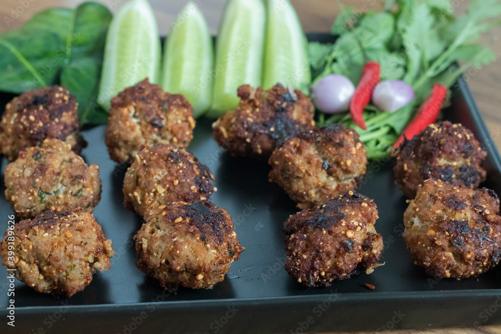 Thai minced pork balls with roasted rice called Larb Moo Tod